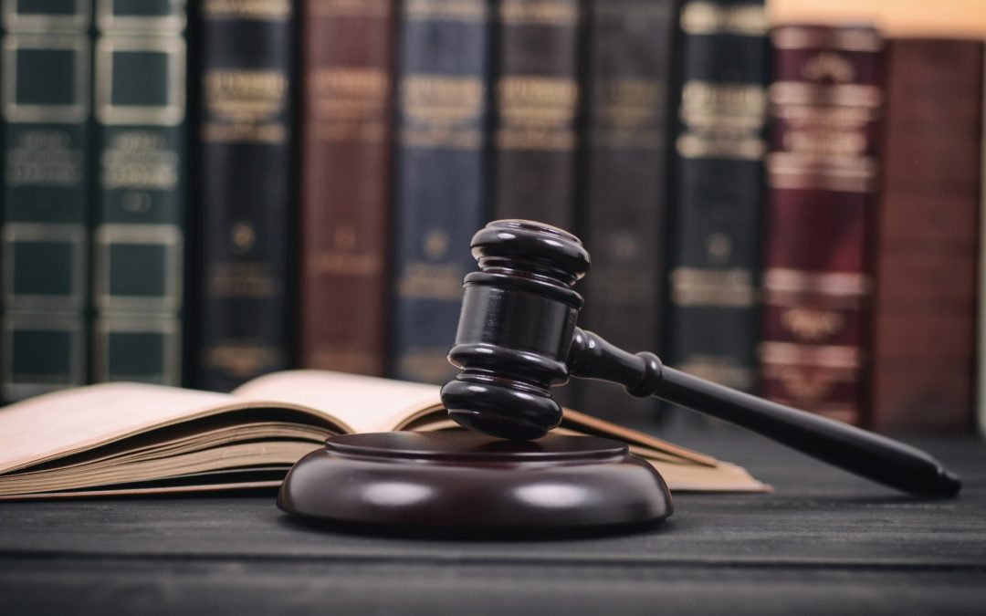 Hammer and gavil on desk in law office with books