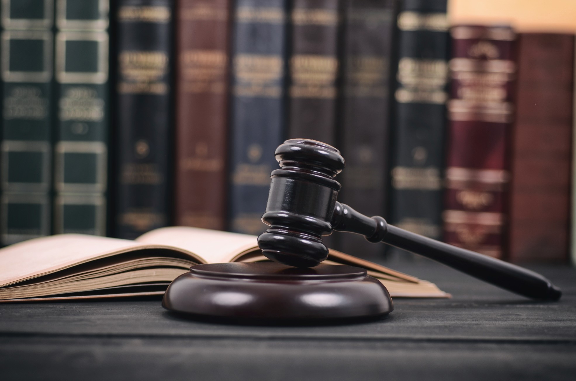 Hammer and gavil on desk in law office with books