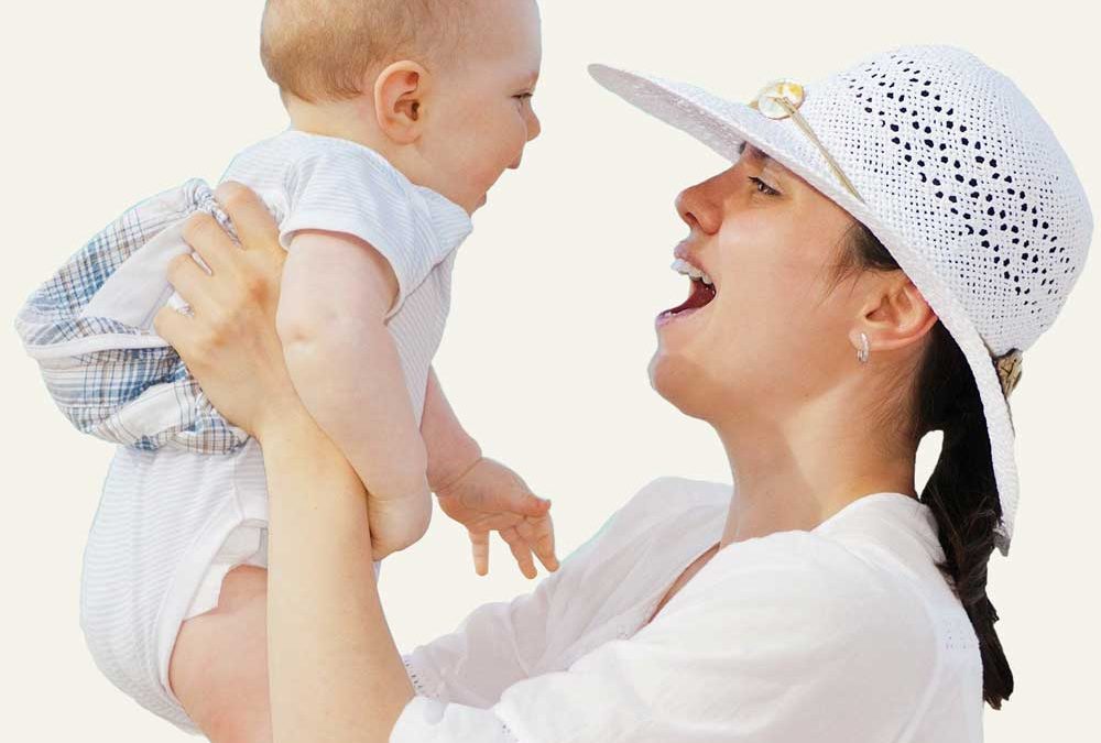 Happy mother holding baby in air